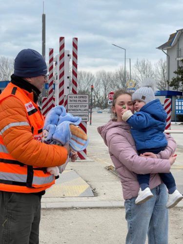 Danny greeting mother and toddler with a friendly lollypop and a warm blanket.